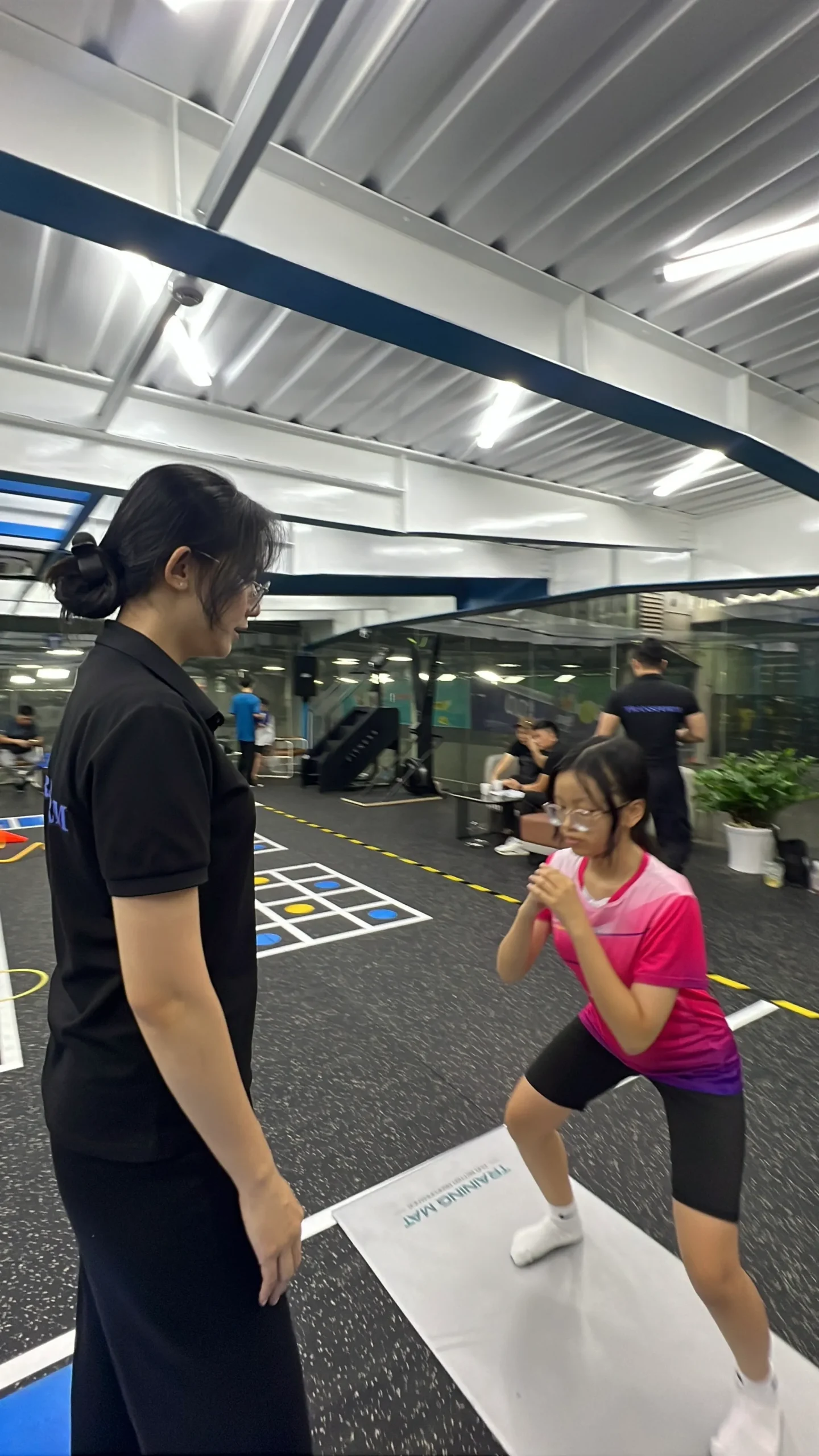 A Transform Kid coach supervising a child’s movement practice in Vietnam