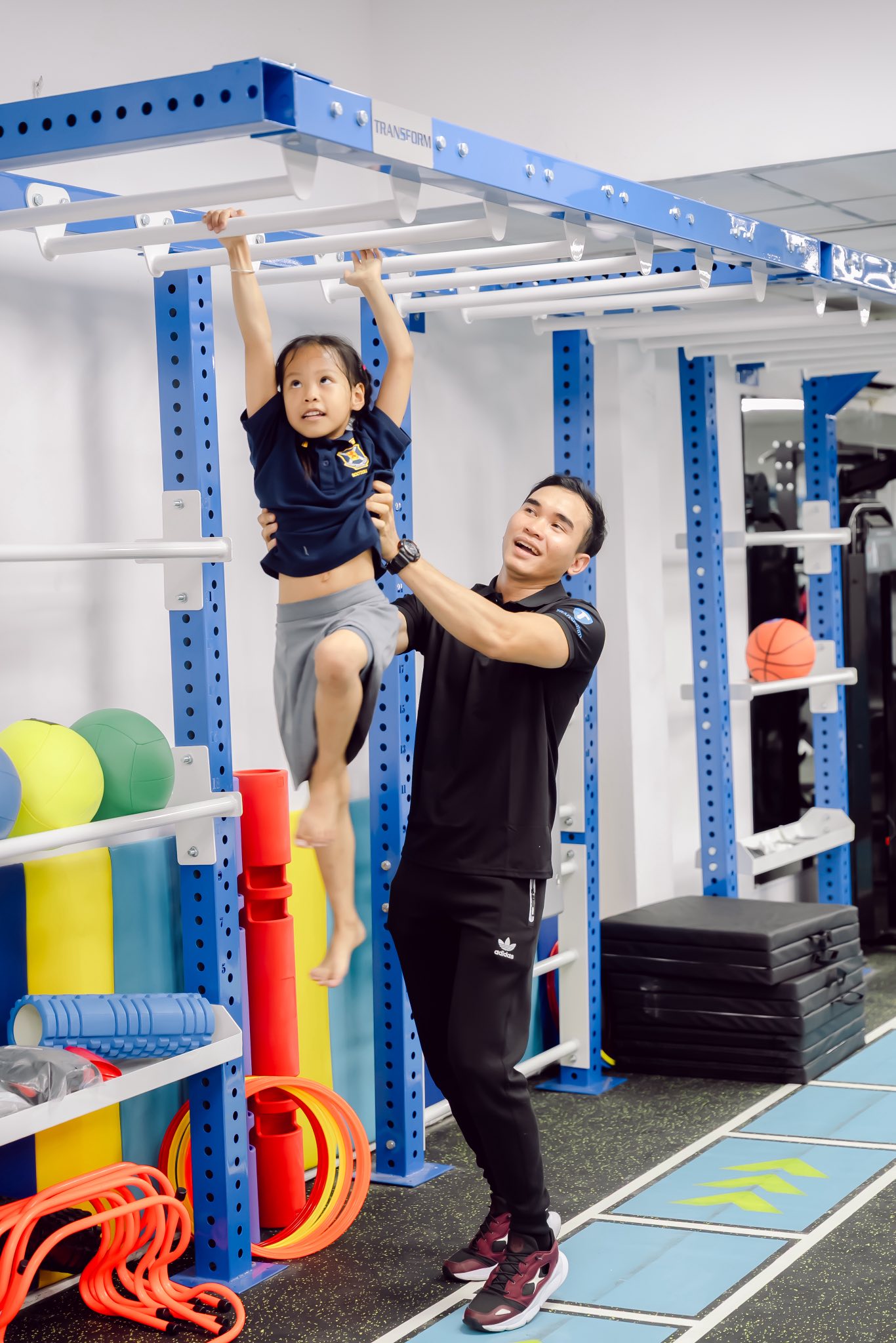 A Transform Kid coach supporting a child during training